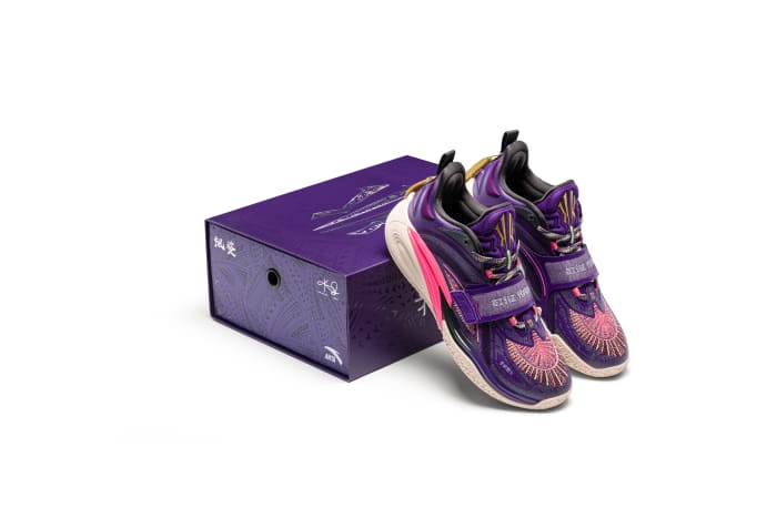 Kyrie Irving's purple ANTA sneakers propped on a box.